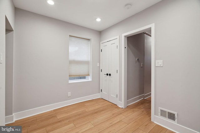 spare room with light hardwood / wood-style flooring