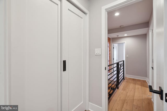 hallway with light hardwood / wood-style flooring