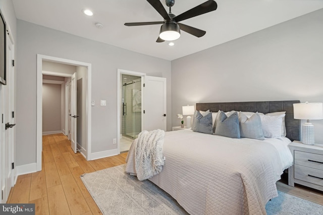 bedroom featuring ceiling fan, light wood-type flooring, and ensuite bathroom