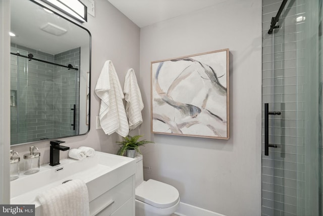 bathroom featuring vanity, toilet, and walk in shower