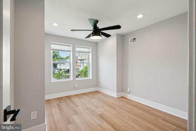 spare room featuring light hardwood / wood-style flooring and ceiling fan