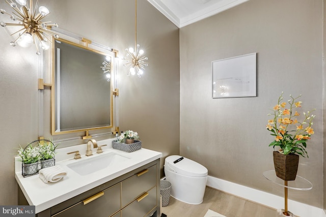 bathroom with hardwood / wood-style flooring, vanity, toilet, and crown molding