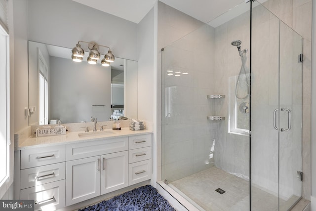 bathroom featuring vanity and a shower with shower door