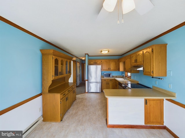 kitchen featuring crown molding, a baseboard radiator, appliances with stainless steel finishes, and sink