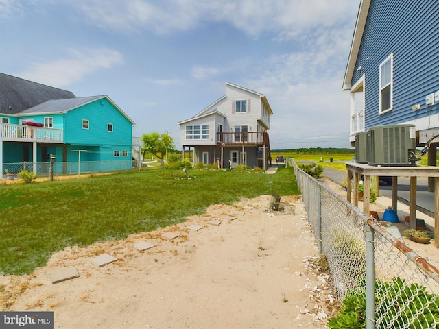 exterior space with cooling unit and a lawn