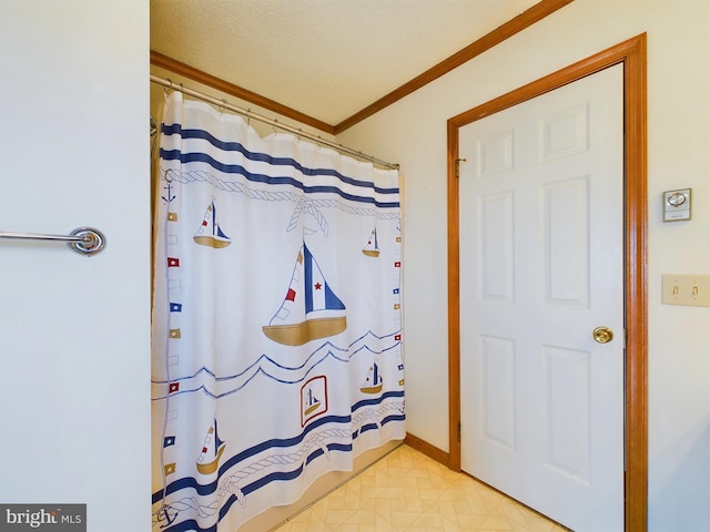 bathroom with crown molding and walk in shower