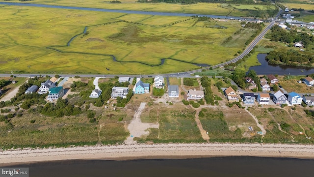 drone / aerial view with a water view and a beach view