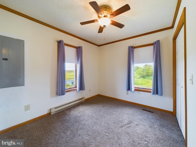 carpeted empty room featuring ornamental molding, a wealth of natural light, electric panel, and baseboard heating