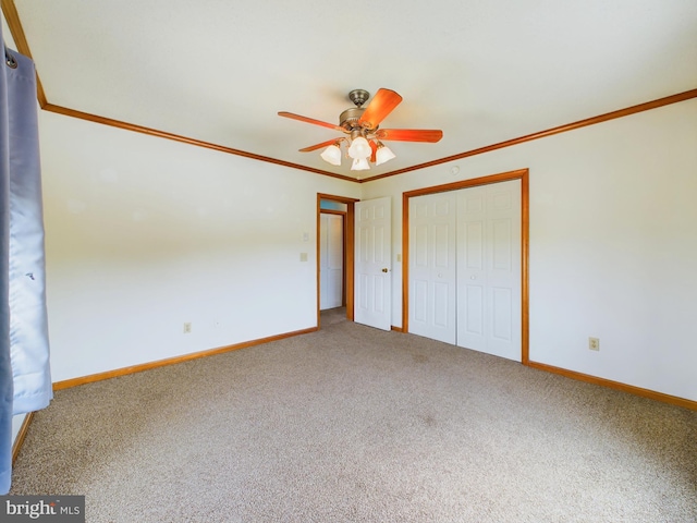 unfurnished bedroom with crown molding, a closet, ceiling fan, and carpet flooring