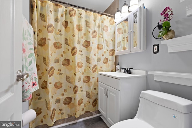 bathroom featuring vanity, curtained shower, and toilet