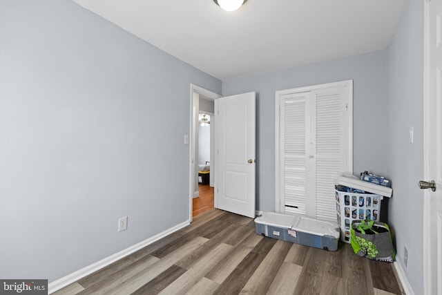 bedroom featuring dark hardwood / wood-style floors and a closet