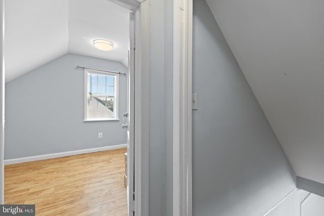 additional living space with lofted ceiling and light wood-type flooring