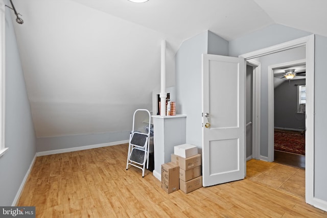 interior space with ceiling fan, lofted ceiling, and light hardwood / wood-style flooring