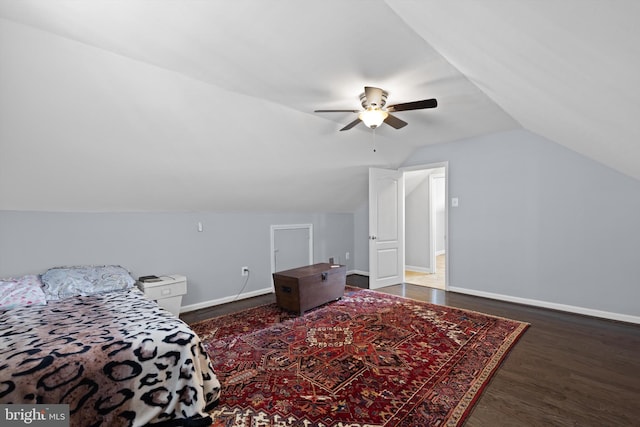 bedroom with ceiling fan, dark hardwood / wood-style floors, and vaulted ceiling