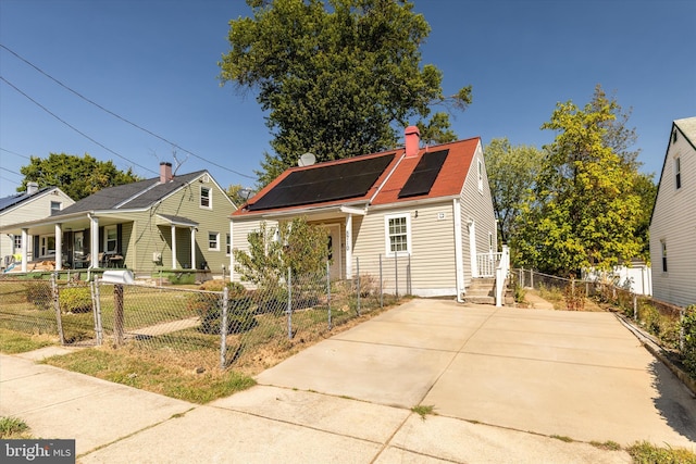 bungalow-style home featuring solar panels, a gate, a fenced front yard, and a chimney