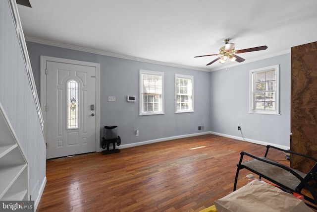 entrance foyer featuring dark hardwood / wood-style flooring, ceiling fan, and crown molding