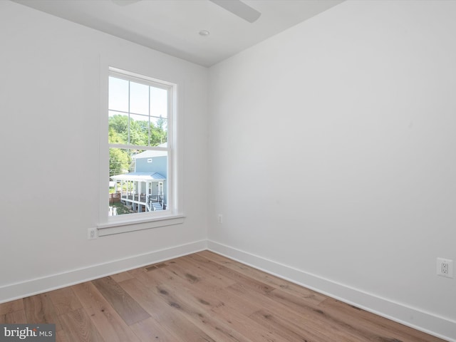 unfurnished room with light wood-type flooring and ceiling fan