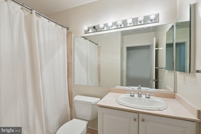 bathroom featuring vanity, toilet, and a shower with shower curtain