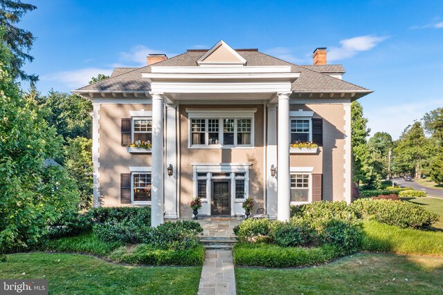 greek revival house with a front yard