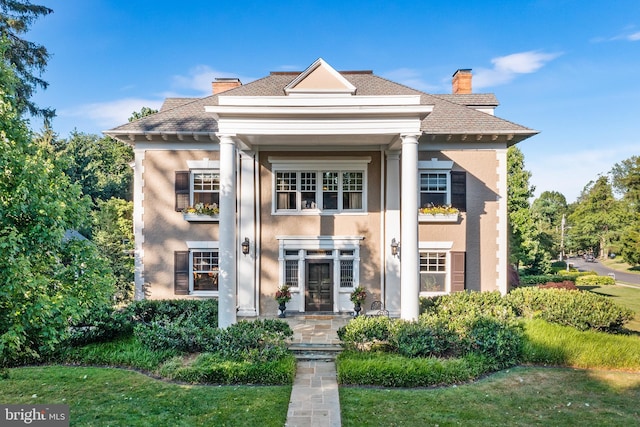 neoclassical / greek revival house with a front lawn