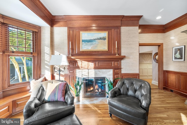 living area with a high end fireplace and light wood-type flooring