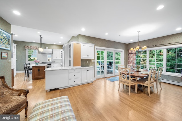 dining space featuring a chandelier, light hardwood / wood-style floors, and baseboard heating