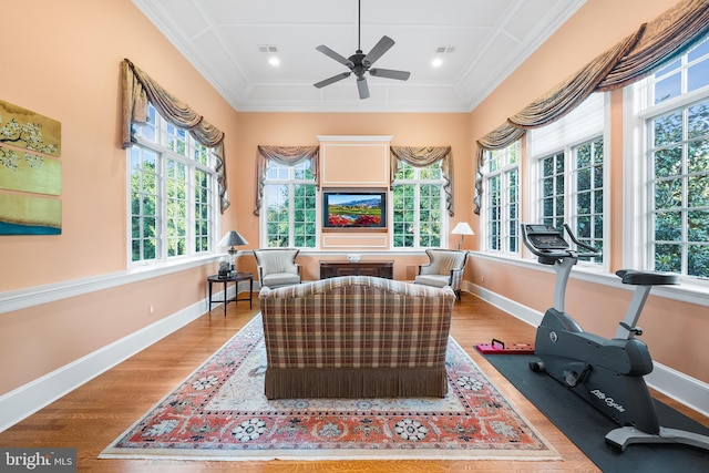 interior space with a wealth of natural light, wood-type flooring, and ornamental molding