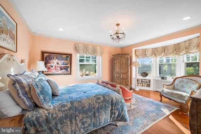 bedroom featuring multiple windows, wood-type flooring, and ornamental molding