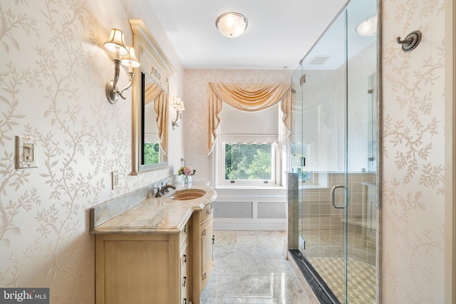 bathroom with vanity and a shower with door