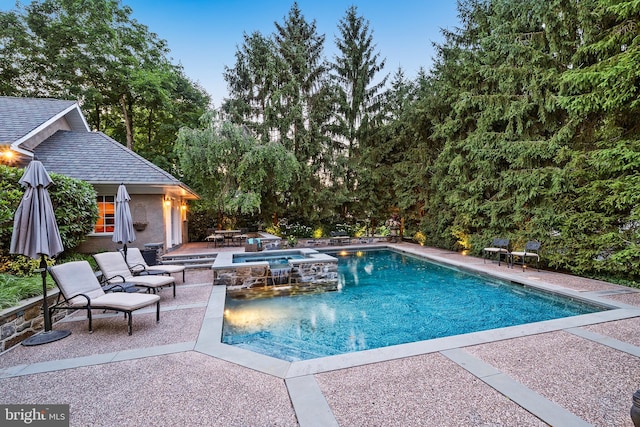 view of swimming pool featuring an outbuilding and a patio area