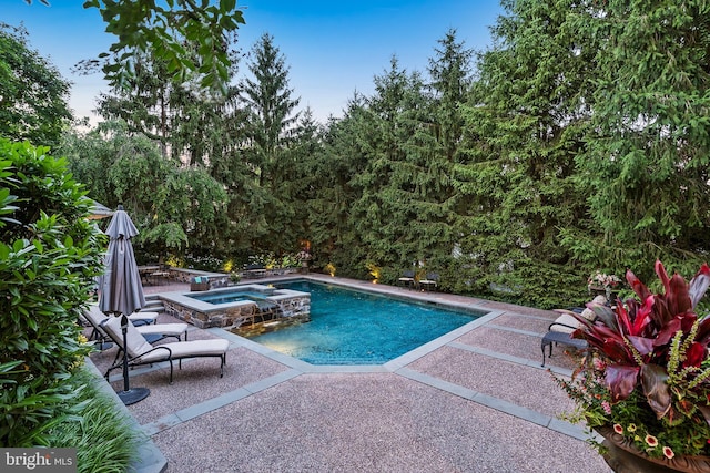 view of swimming pool featuring a patio and an in ground hot tub