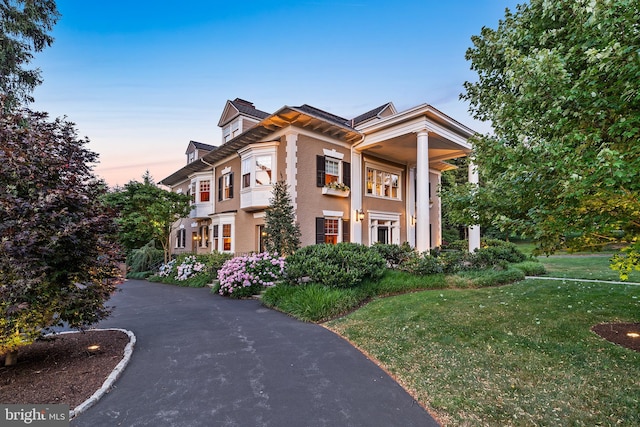 greek revival house featuring a lawn