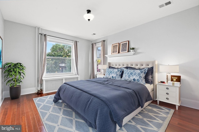 bedroom with dark wood-type flooring