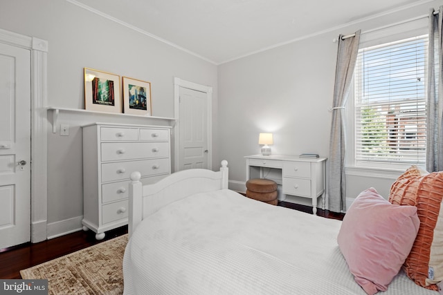 bedroom with crown molding and dark wood-type flooring