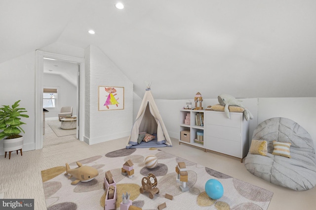 playroom with light carpet and vaulted ceiling