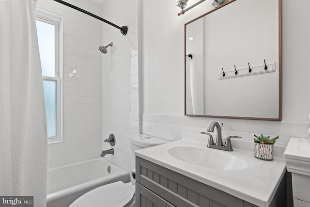 full bathroom featuring toilet, vanity, and tiled shower / bath combo