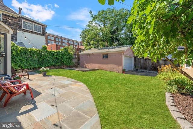 view of yard with a patio area, an outbuilding, and a garage