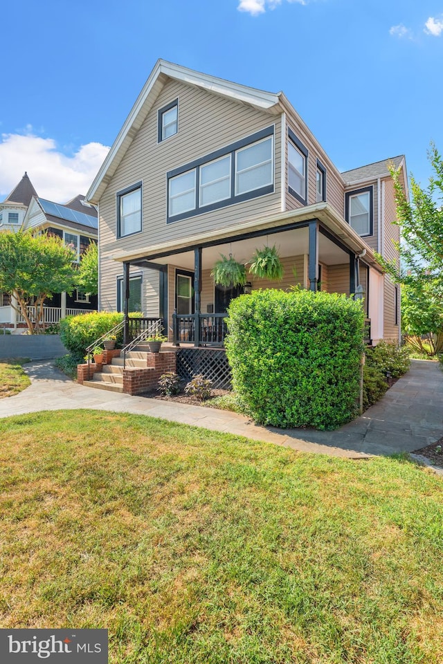 view of front of house with a porch and a front lawn