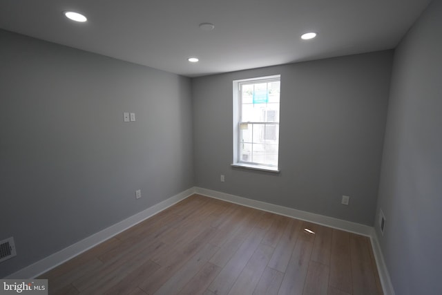 empty room with light hardwood / wood-style flooring