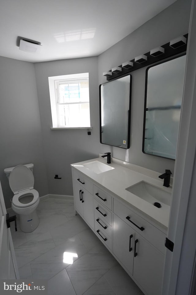 bathroom featuring vanity and toilet