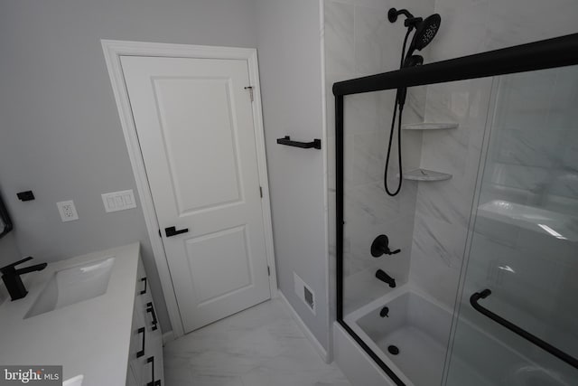 bathroom with vanity and enclosed tub / shower combo