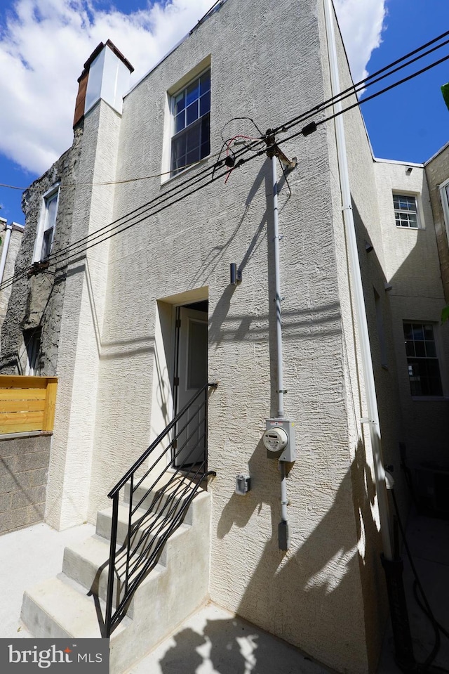 view of side of property with basketball hoop