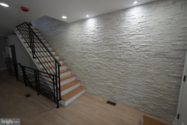 stairs with hardwood / wood-style floors