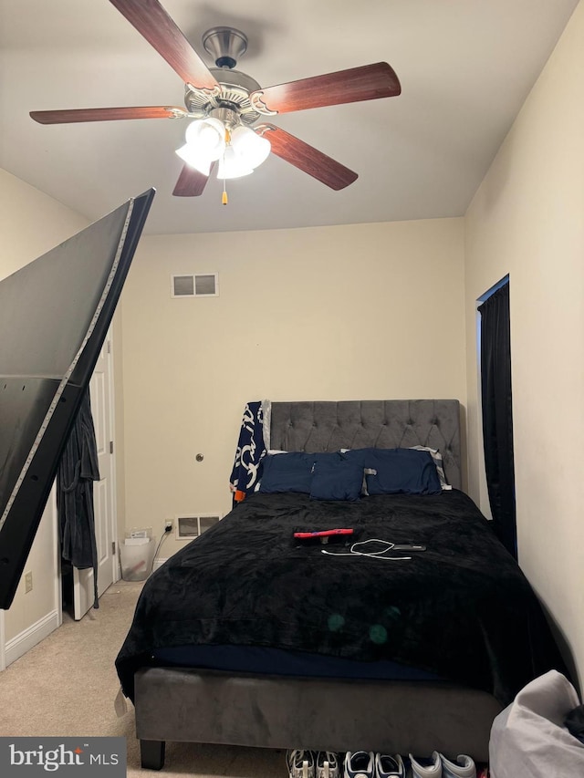 bedroom with ceiling fan and light colored carpet