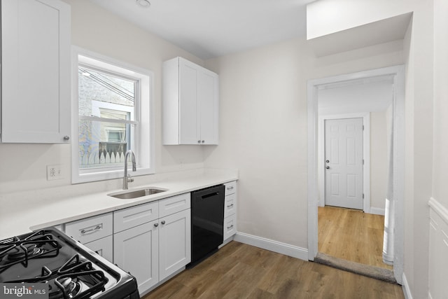 kitchen featuring white cabinets, dark hardwood / wood-style flooring, sink, and black appliances