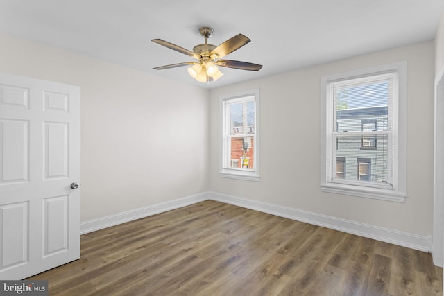 empty room featuring ceiling fan and dark wood-type flooring