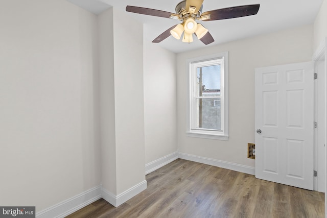 spare room with light hardwood / wood-style flooring and ceiling fan