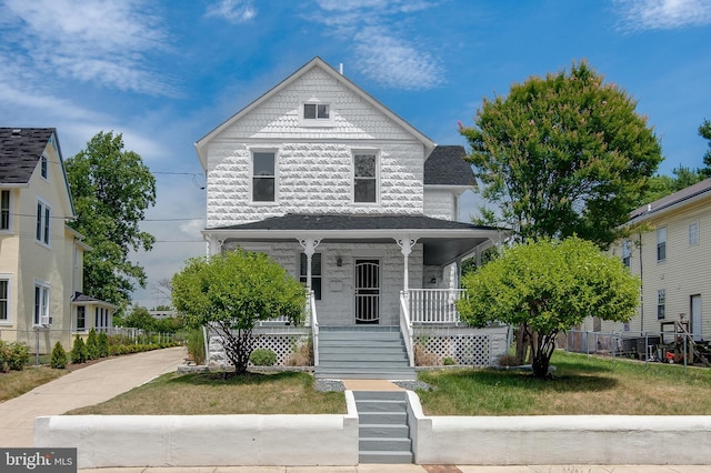 view of front of property with a front yard and a porch