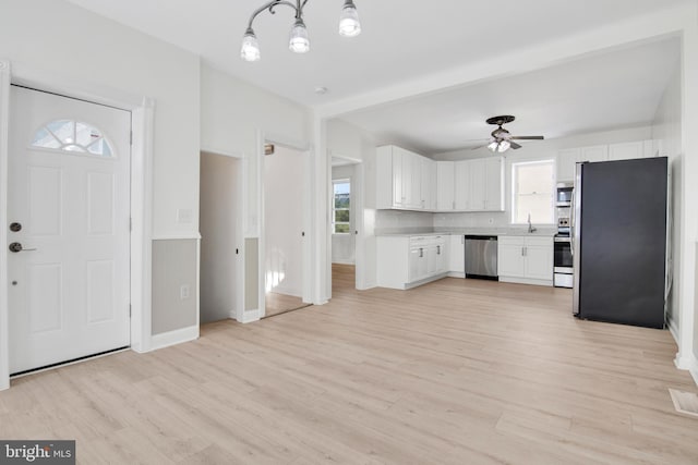 kitchen featuring ceiling fan, light wood-type flooring, white cabinetry, and appliances with stainless steel finishes