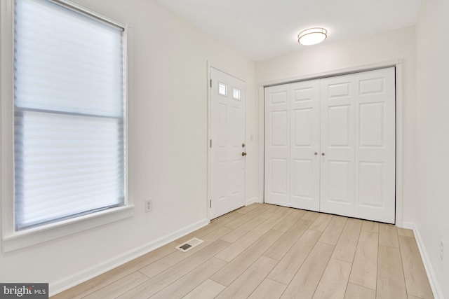 unfurnished bedroom featuring light hardwood / wood-style floors and a closet